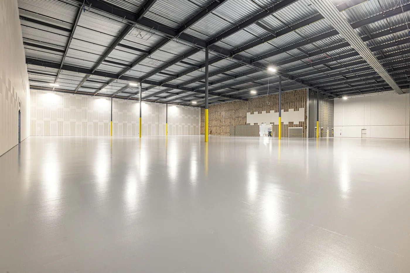 An empty warehouse with a polished concrete floor