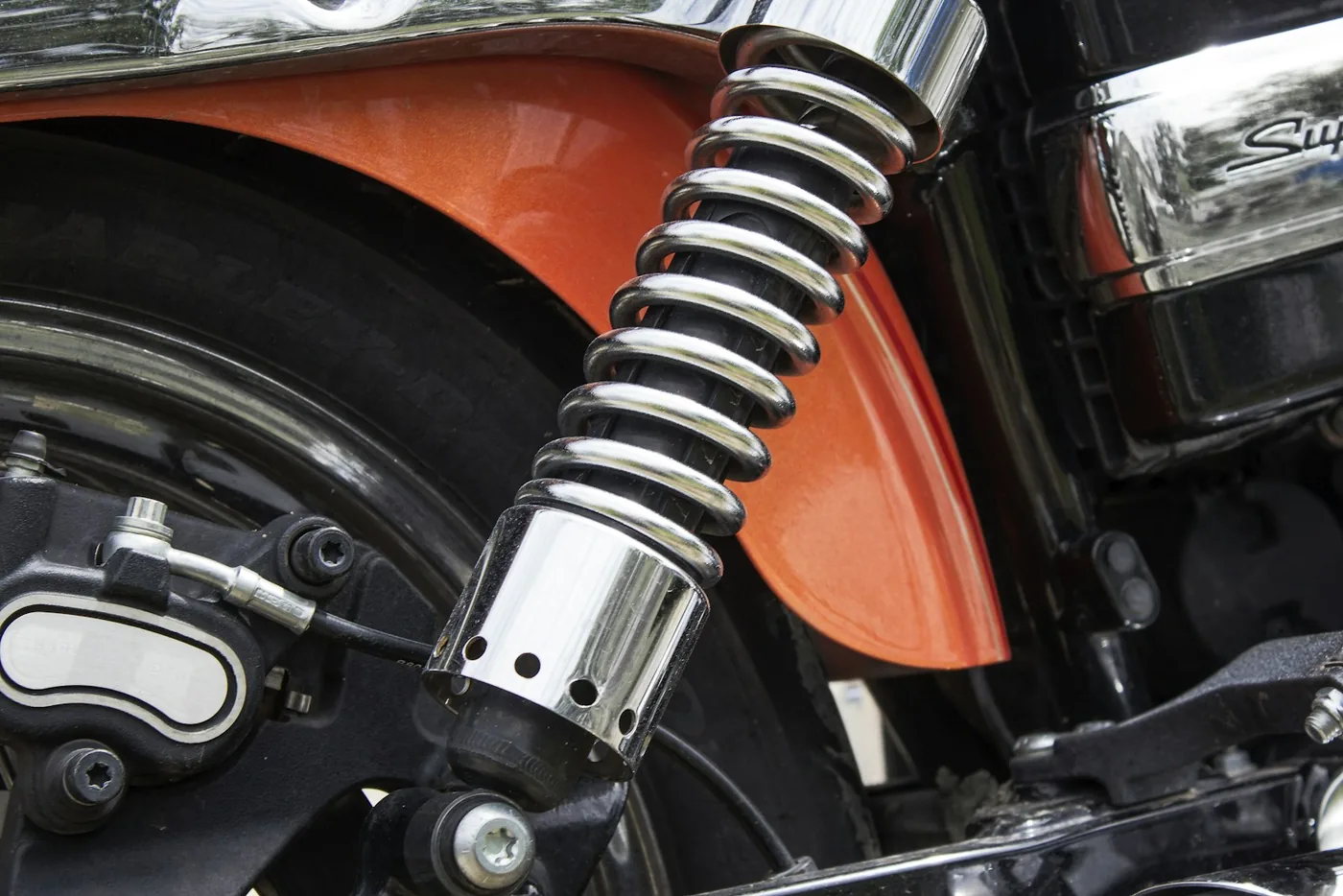 A motorcycle rear shock absorber and spring