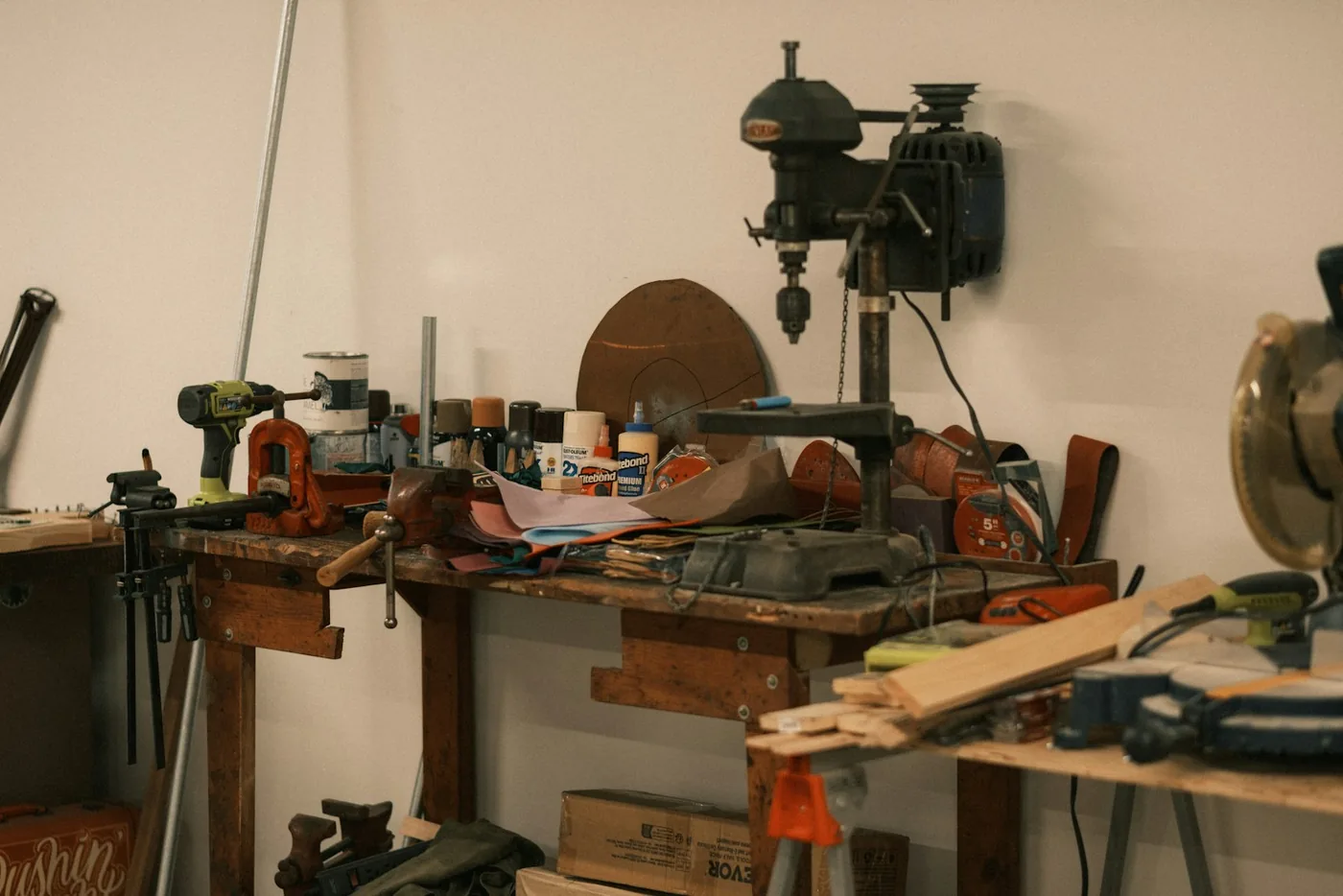 A cluttered workbench with tools and supplies