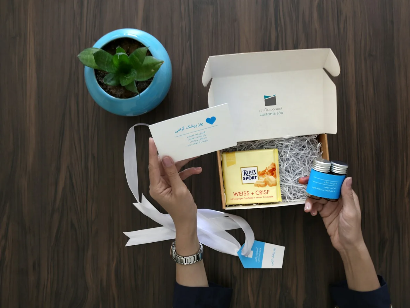 A small package being opened by hand