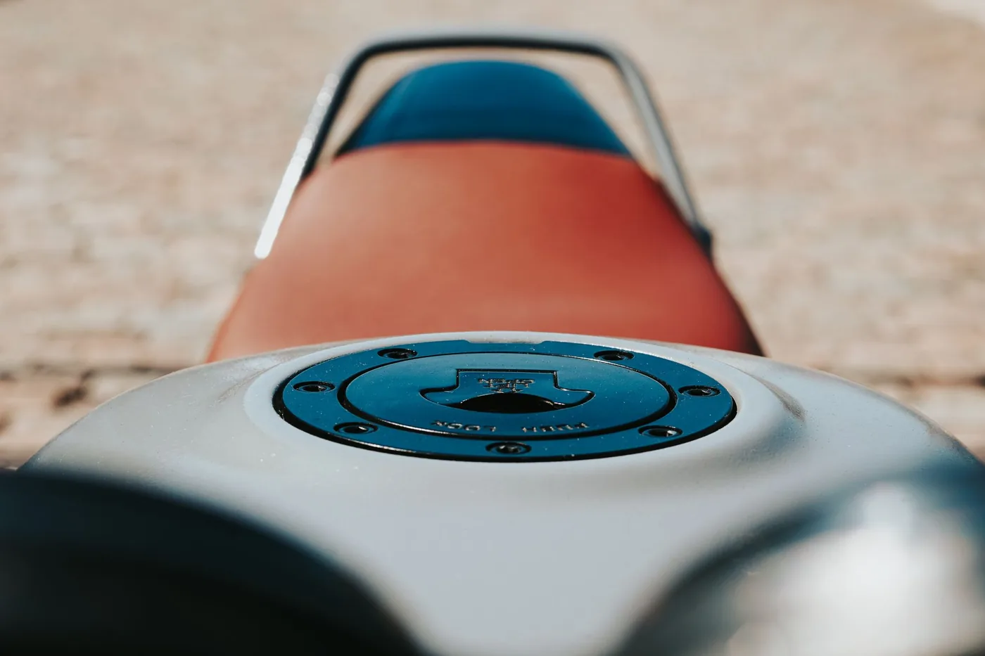 The fuel tank and seat of a small motorcycle