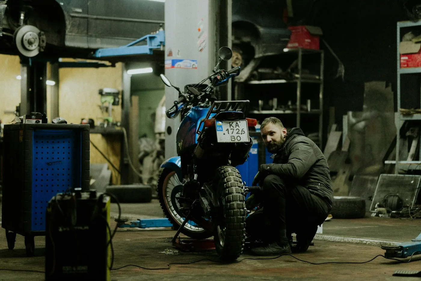 A man working on a motorcycle in a garage