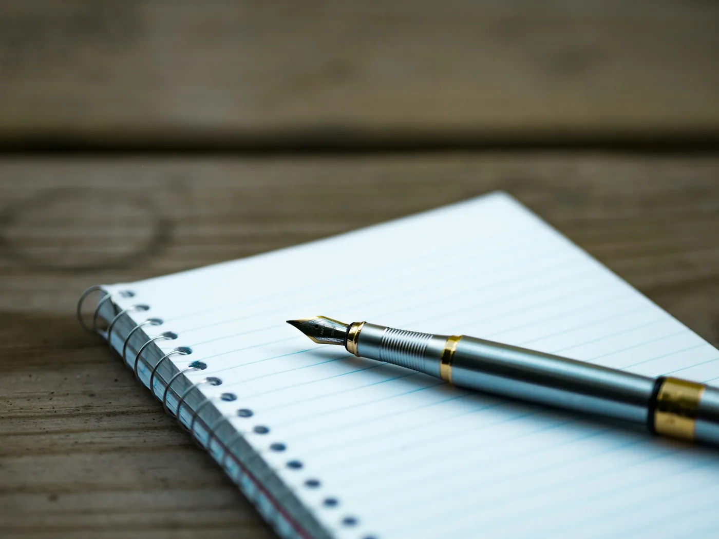 A handwritten list on a notepad beside workshop tools