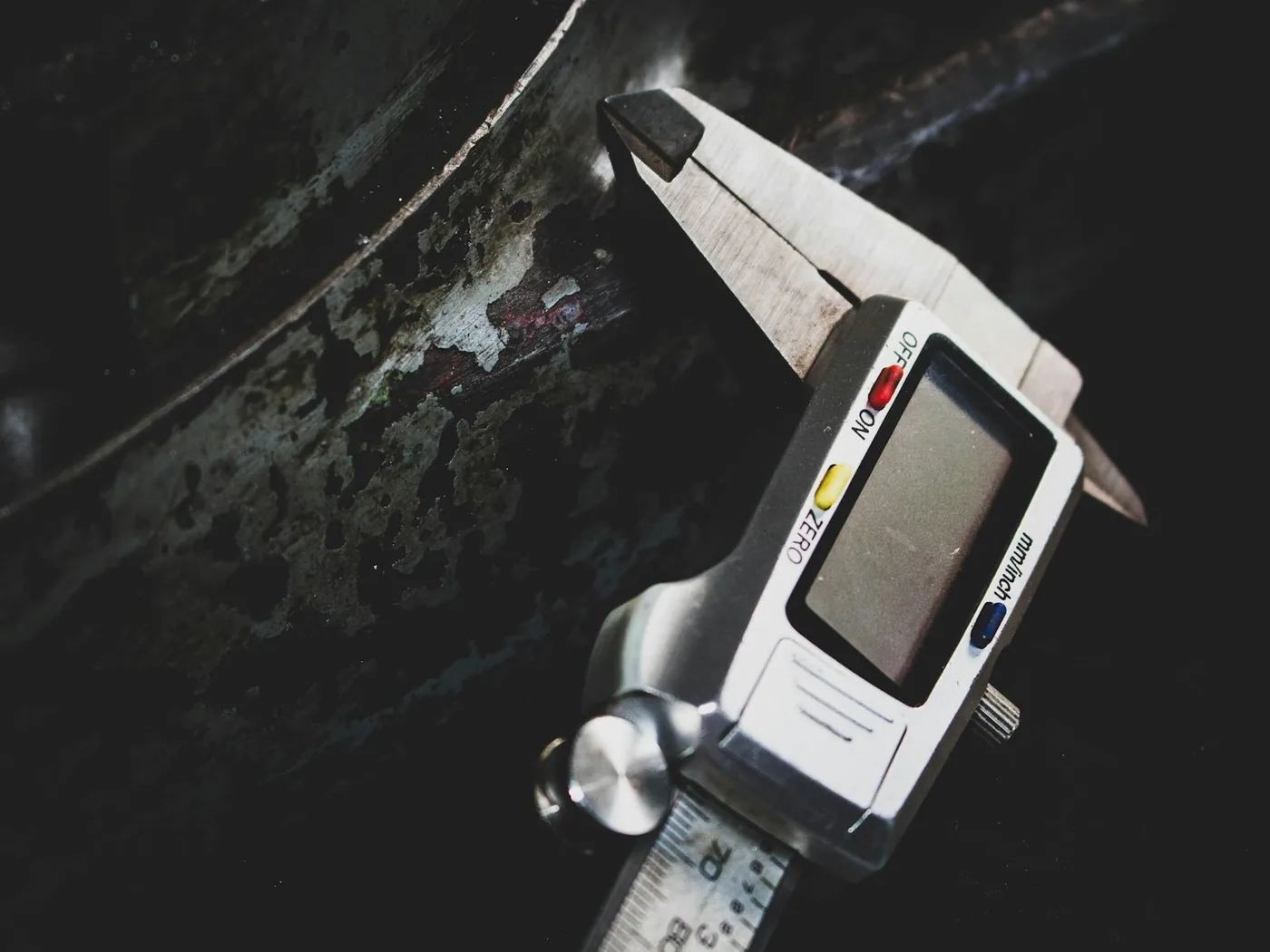 A caliper measuring a metal component