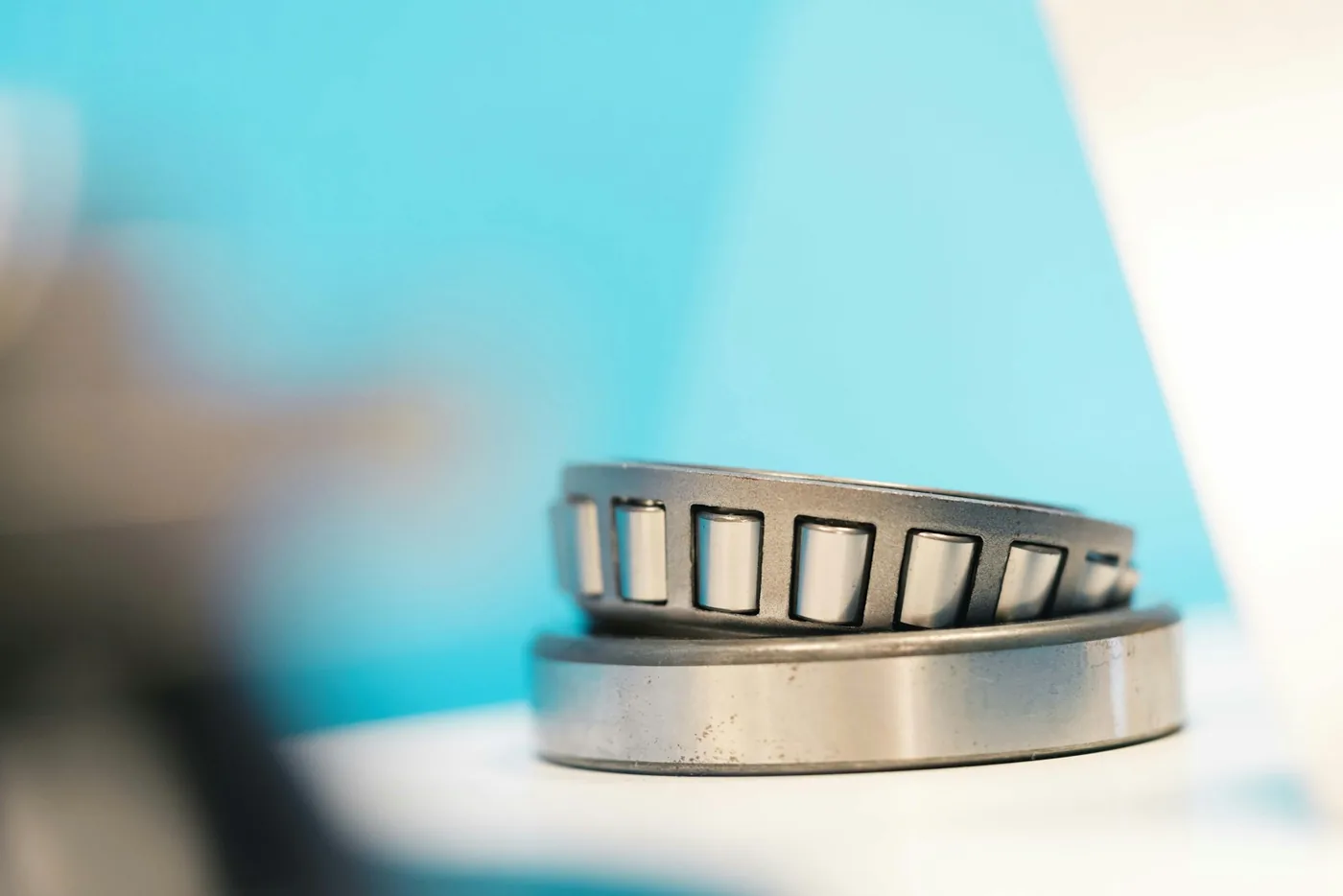 a close up of a metal object with a blue background