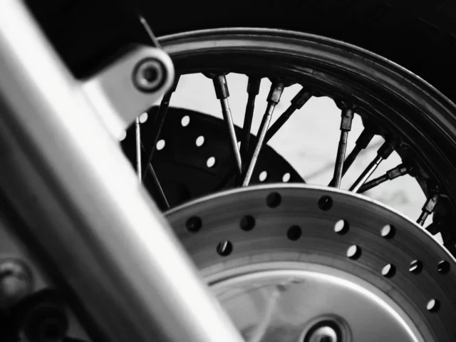 A drilled brake disc on a motorcycle front wheel