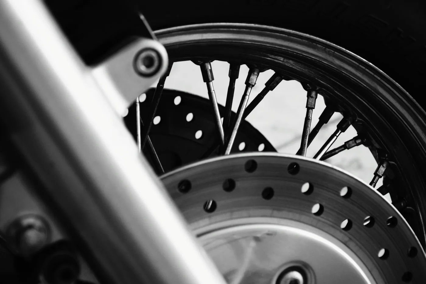A drilled brake disc on a motorcycle front wheel