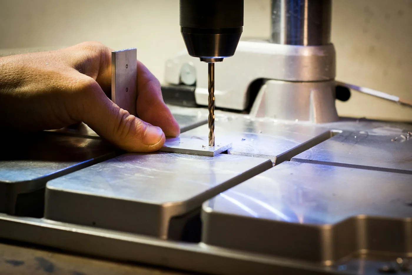 A thin steel blade held against a machined surface