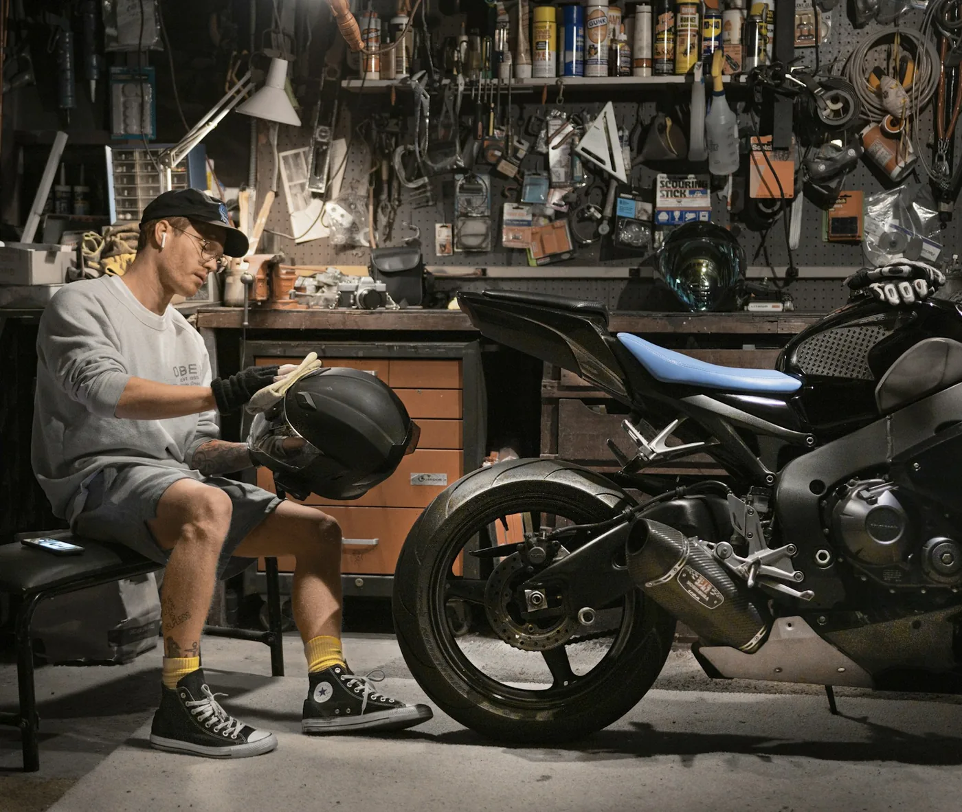 A mechanic at work on a motorcycle in a workshop