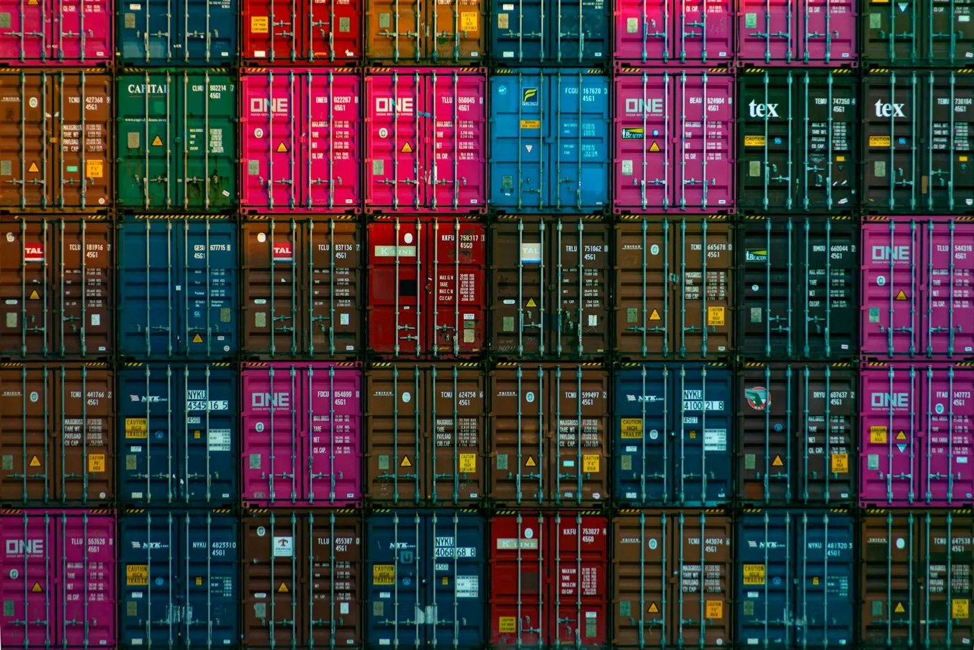 A wall of stacked shipping containers