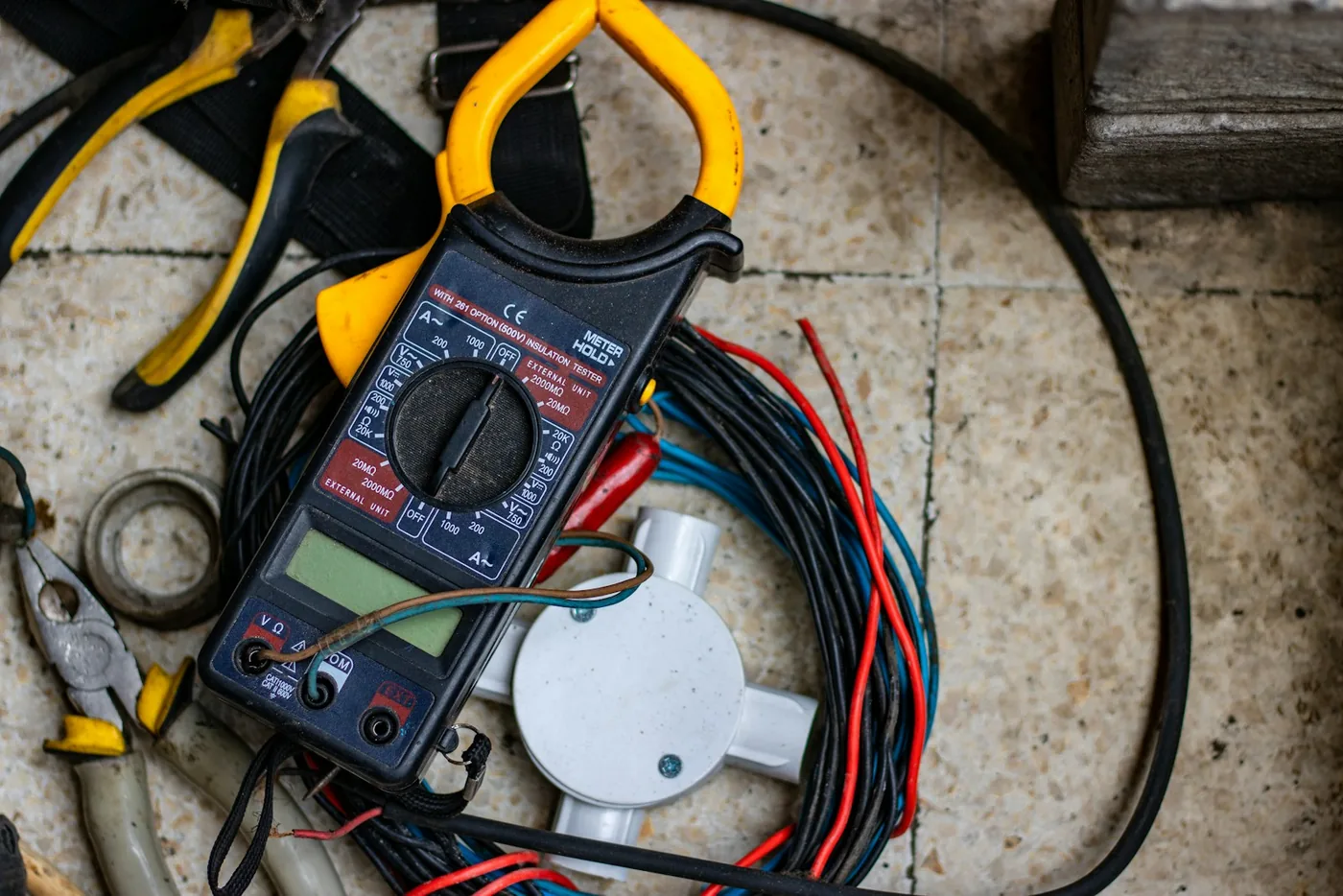A multimeter and its test leads on a bench