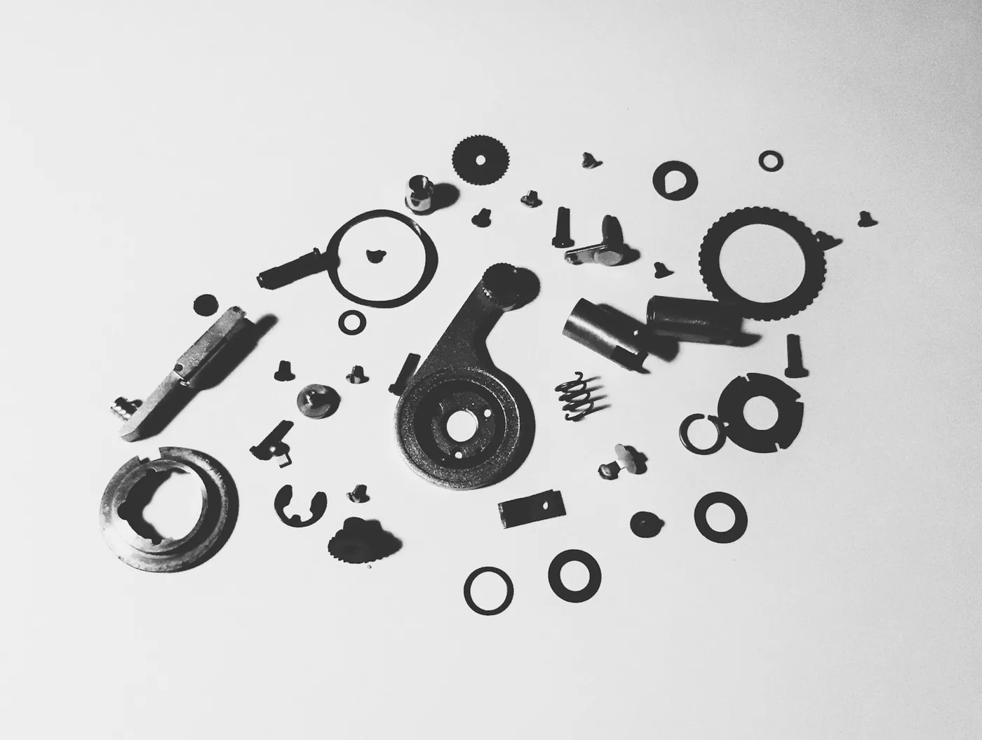 An assortment of small mechanical parts on a white background