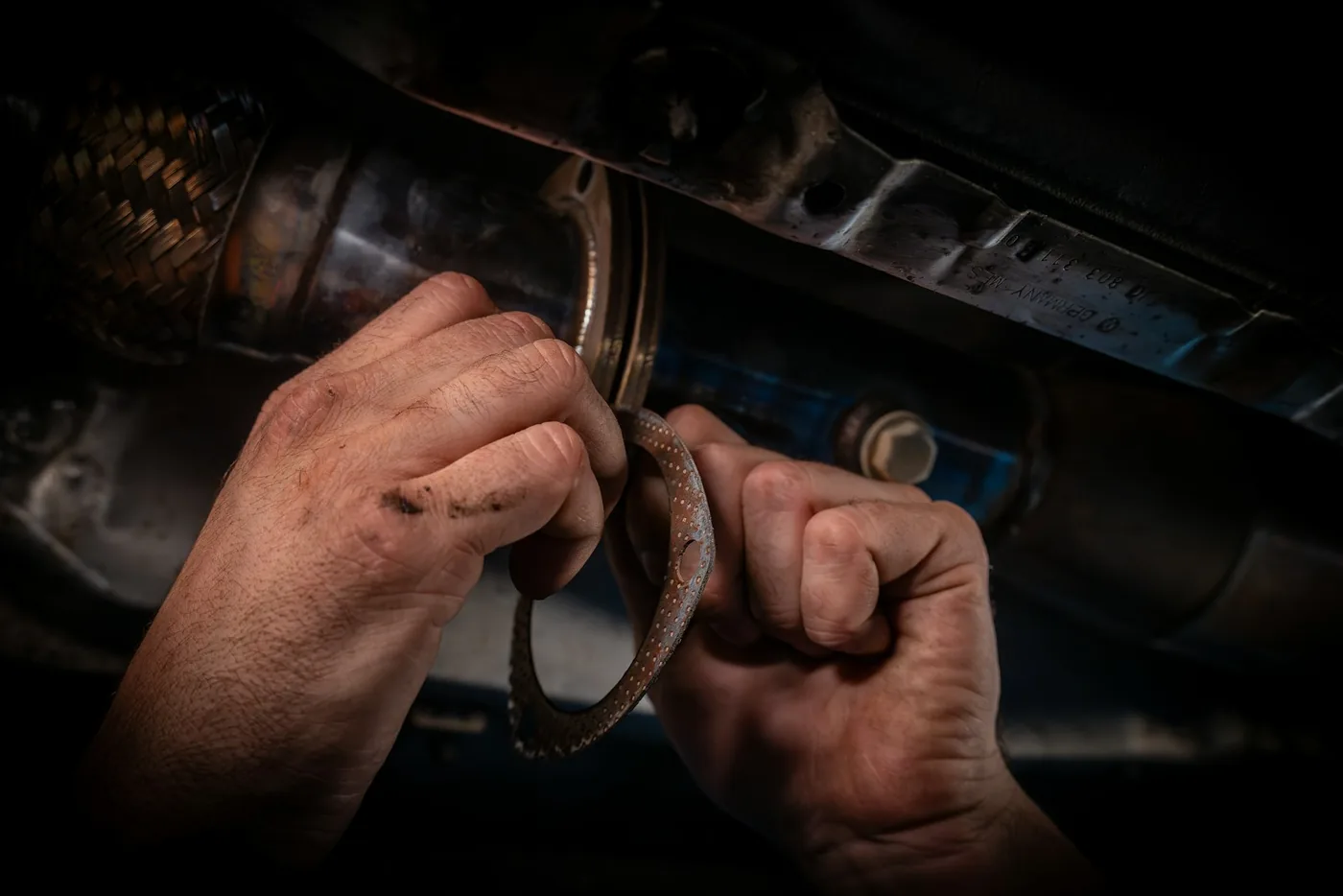 A mechanic working on an engine with a wrench