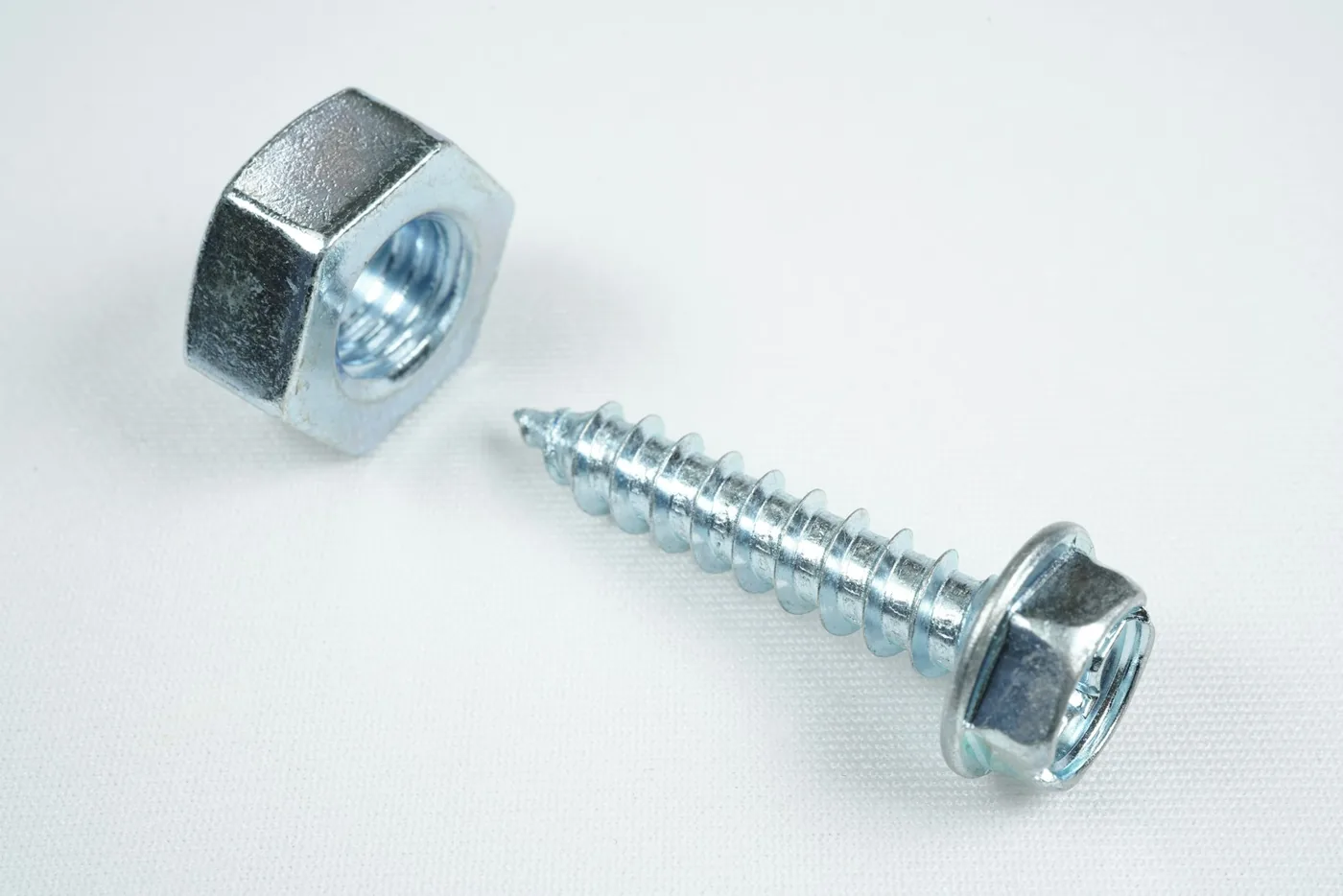 A nut and a self-tapping screw