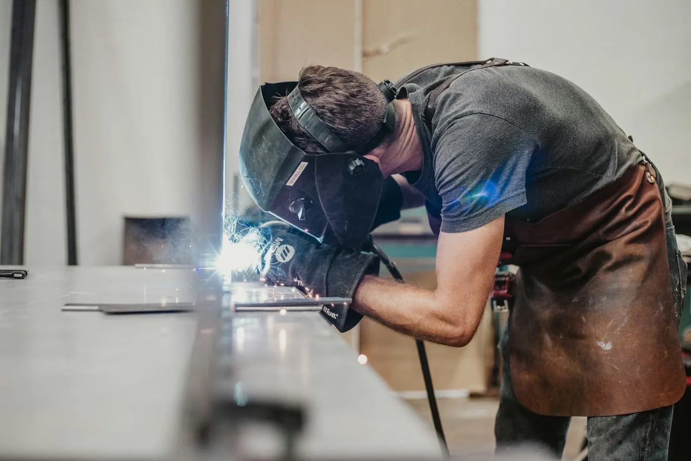 A welder working at a bench