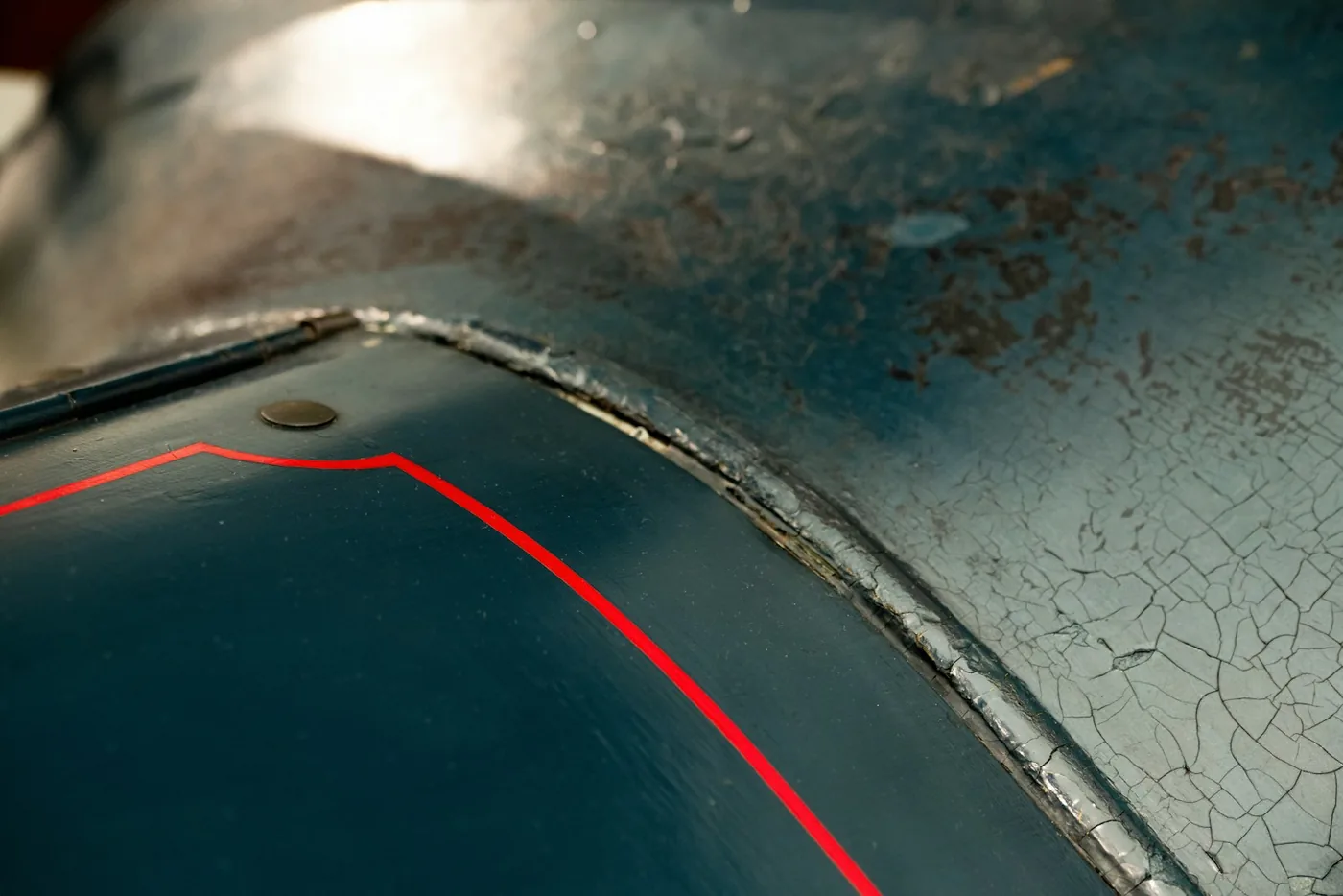 Crazed and cracked paint on an old body panel