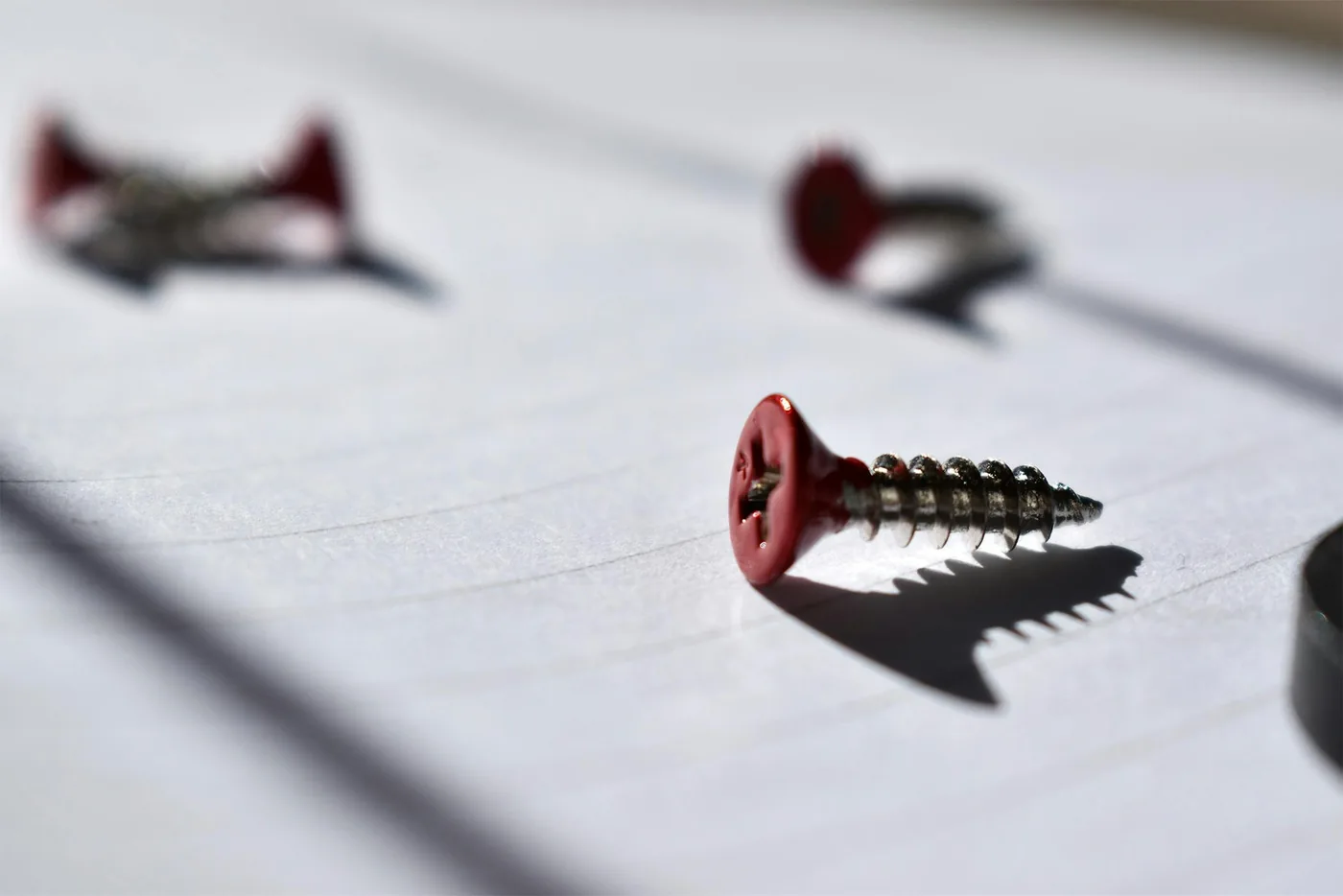 Screws resting on a sheet of paper