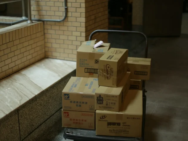 brown cardboard boxes on gray metal rack