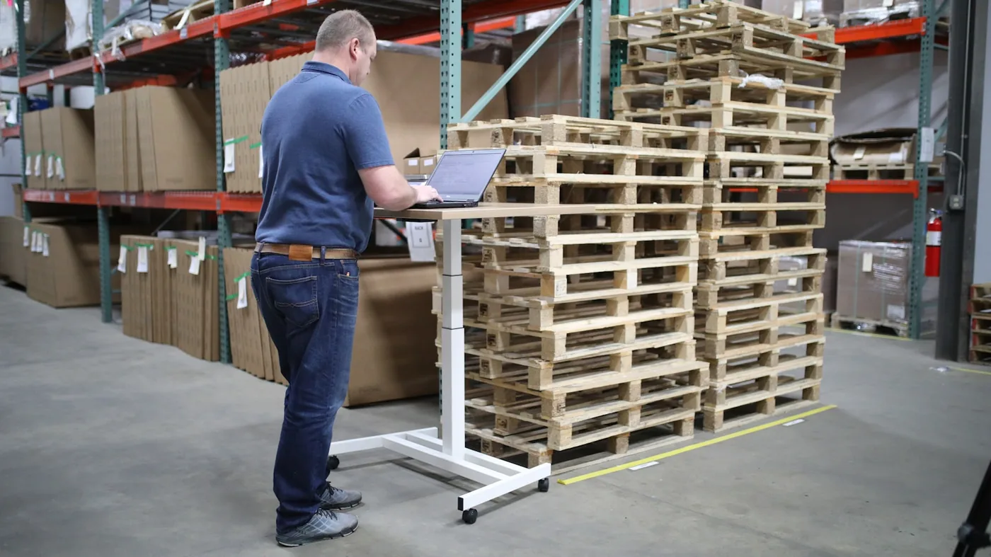 A man checking pallets against a list