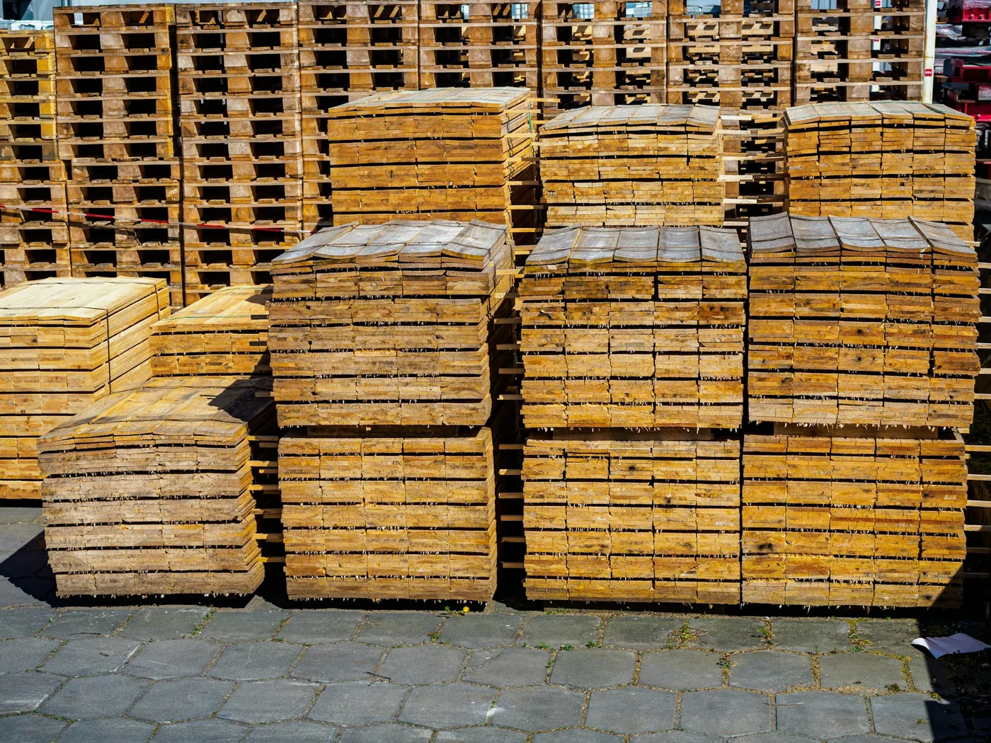 Stacked wooden freight pallets in a yard