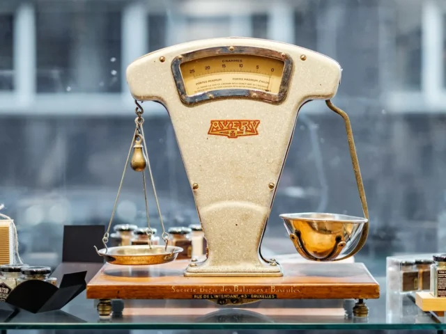 A weighing balance standing on a counter