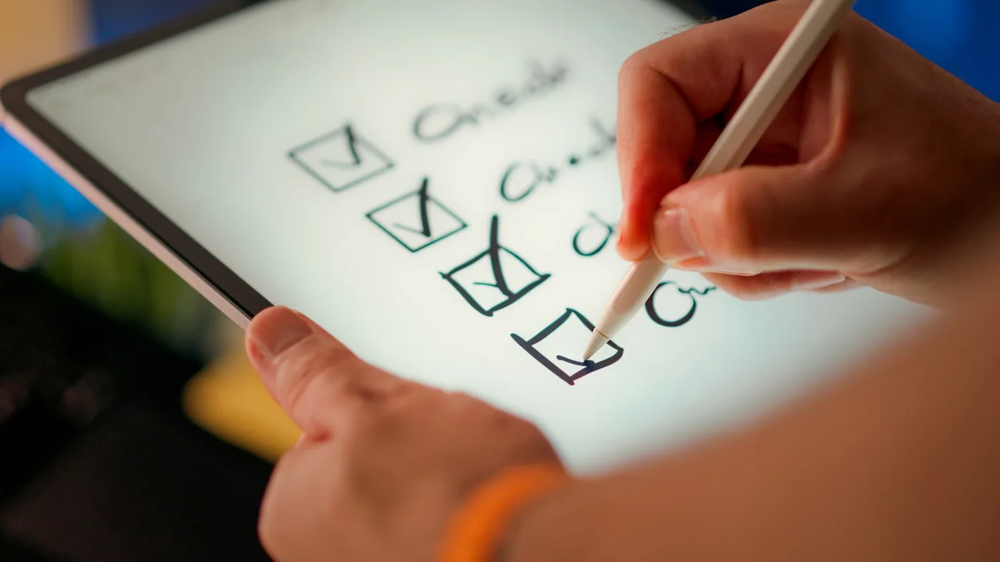 A hand marks off items on a checklist