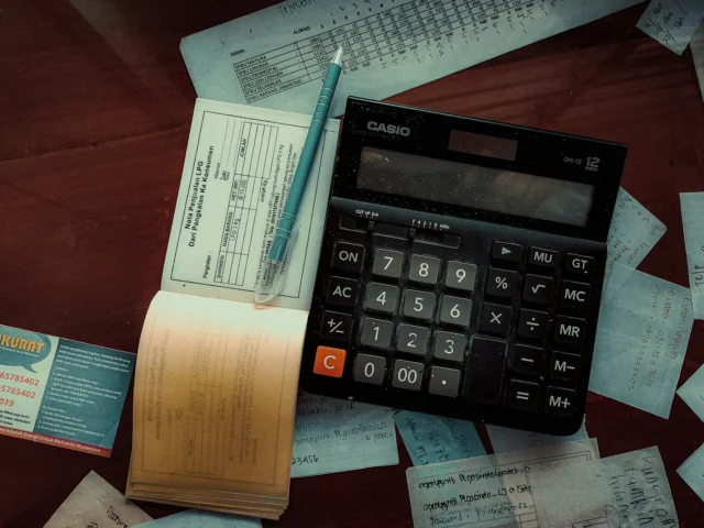 A printed quotation and calculator on a desk