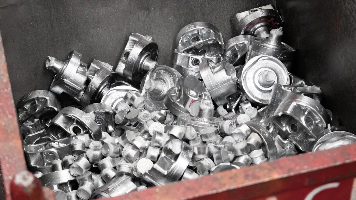 A red box filled with lots of silver objects