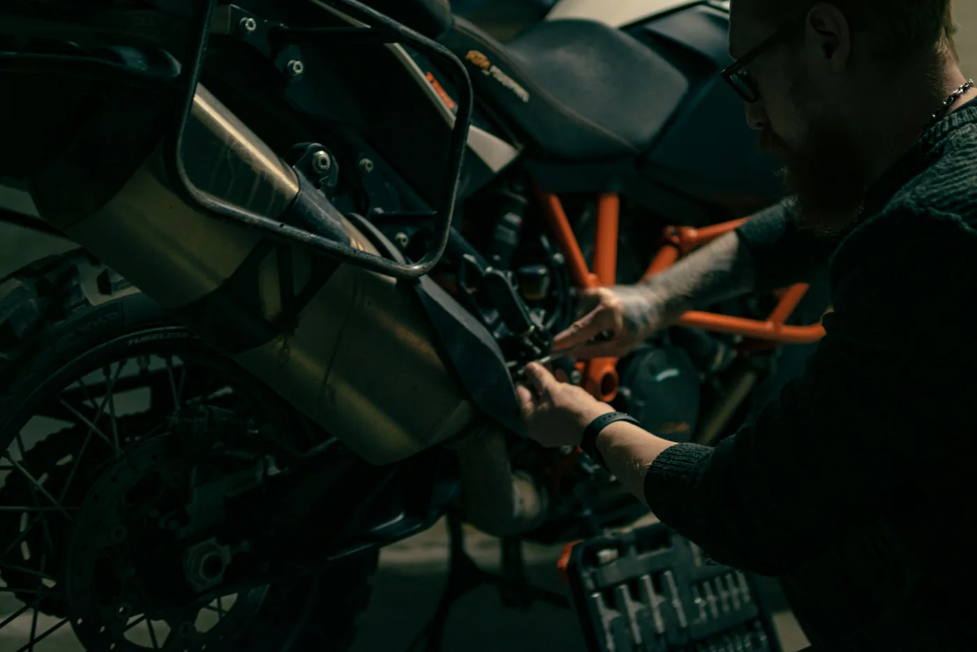 A man working on a motorcycle in a garage