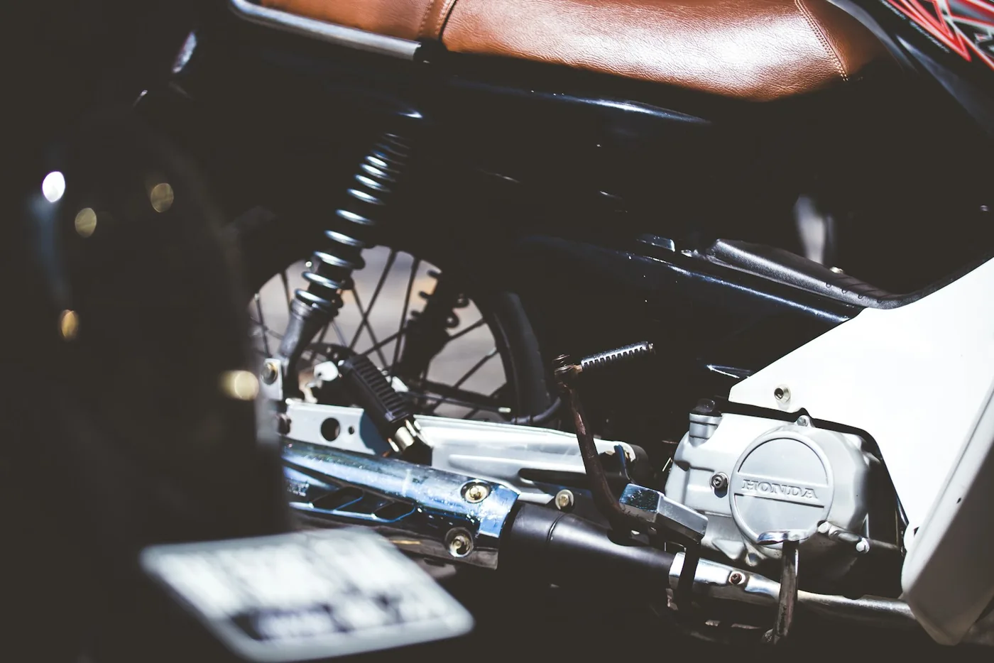 The rear brake linkage and footpeg on a motorcycle