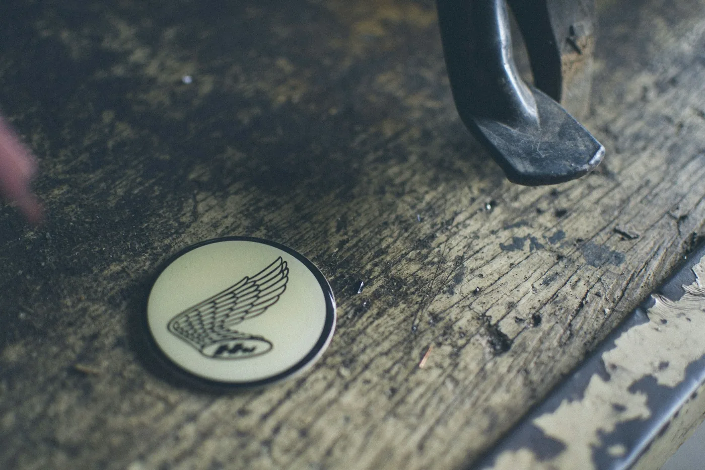 A winged emblem set into a wooden surface