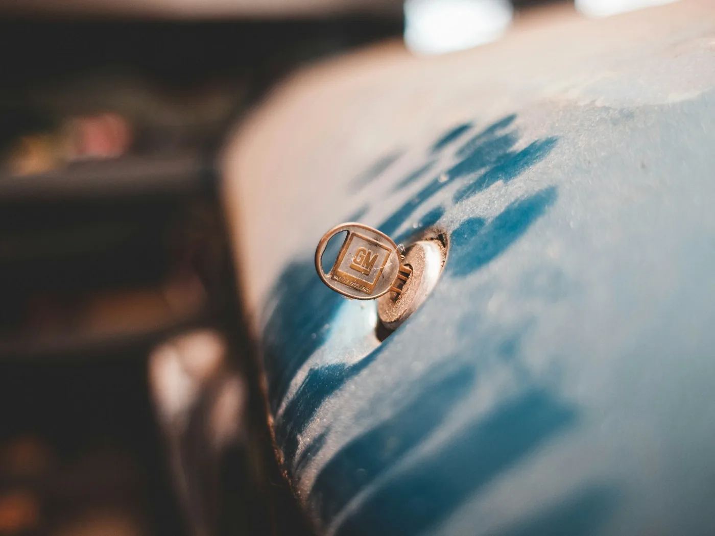 A small metal clip on a painted panel