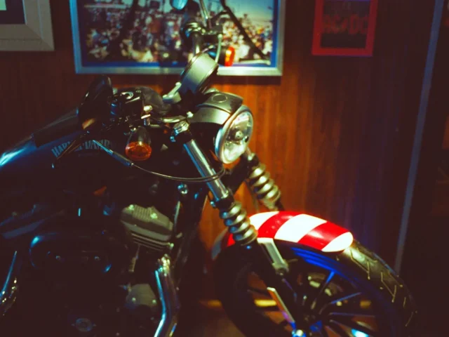 A vintage motorcycle with a red and white stripe