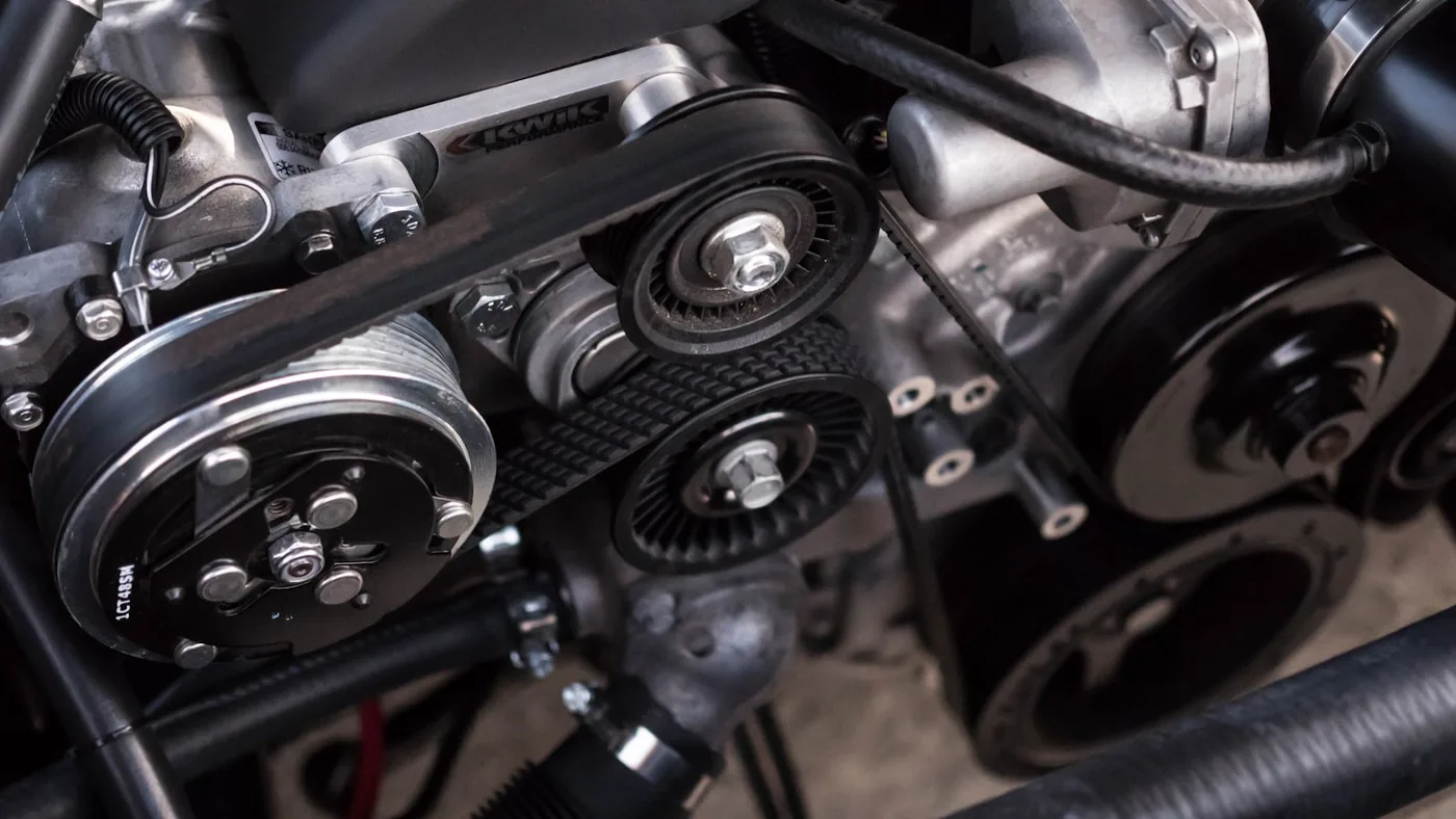 The front of an engine with its belts and pulleys