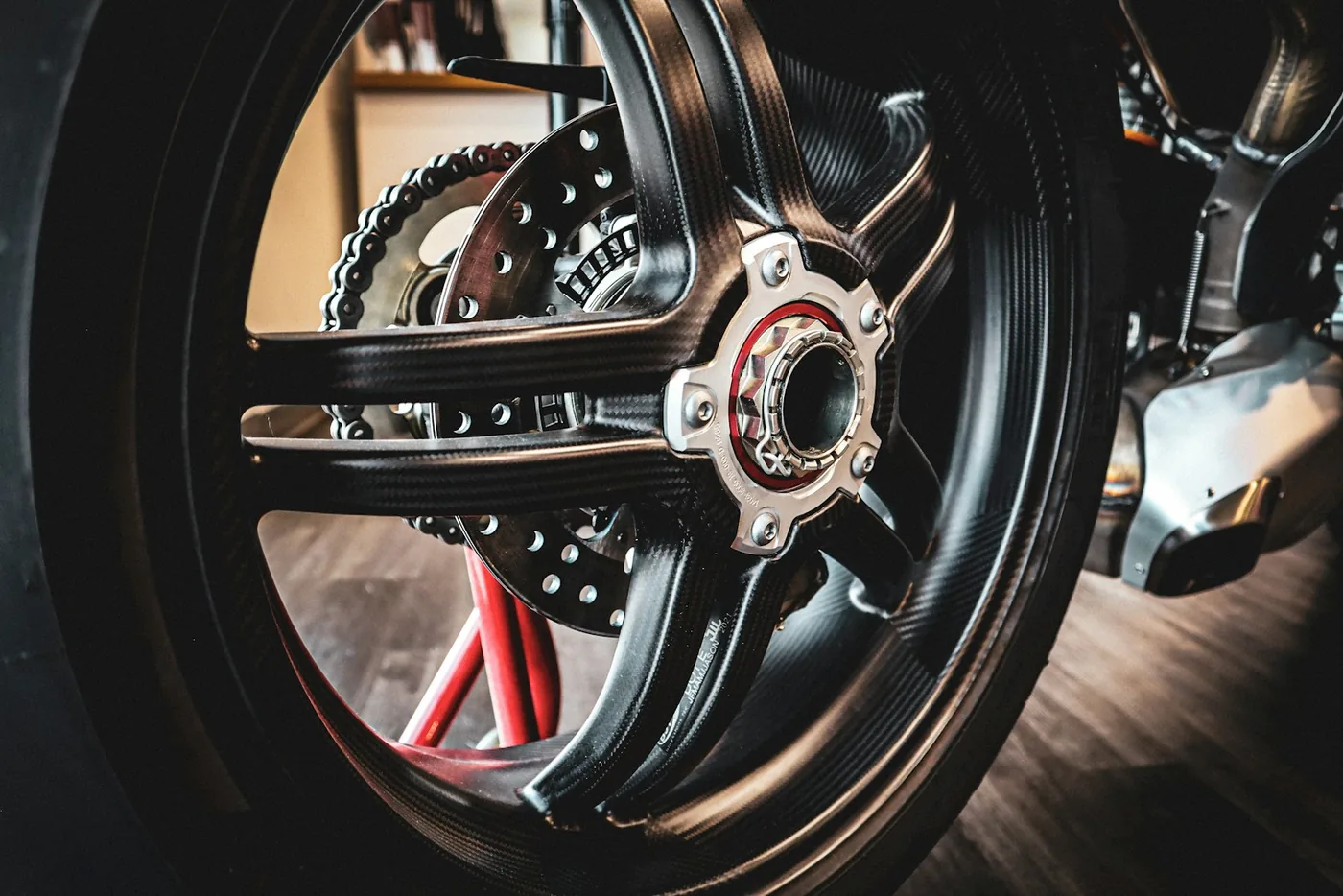 A motorcycle wheel with its chain and sprocket