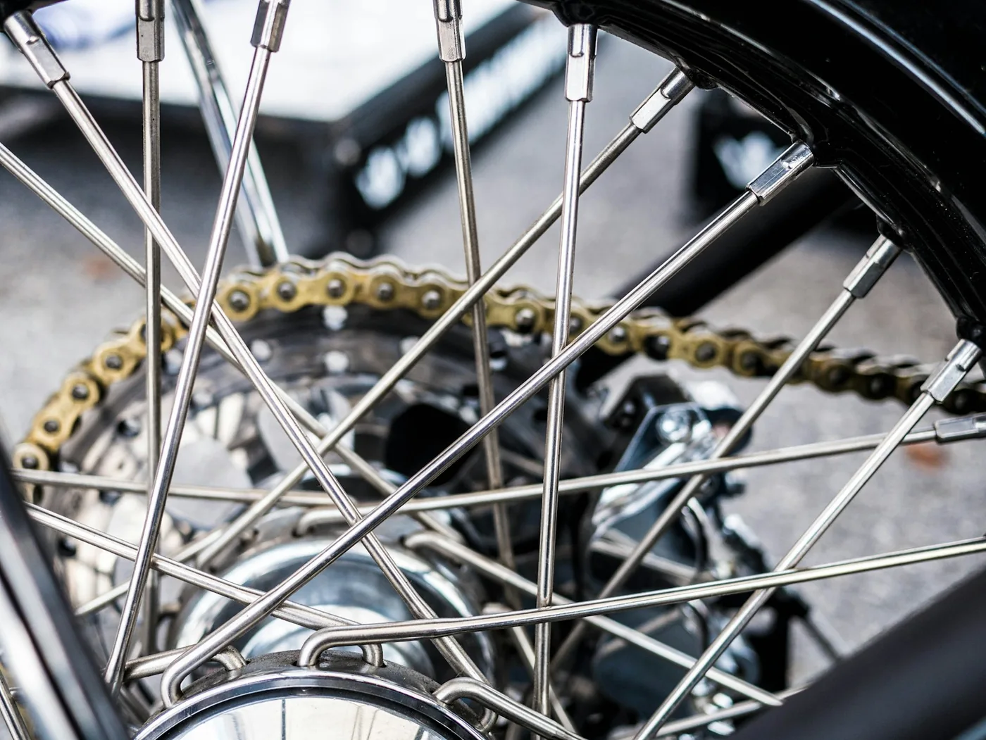 The spokes and chain of a motorcycle wheel
