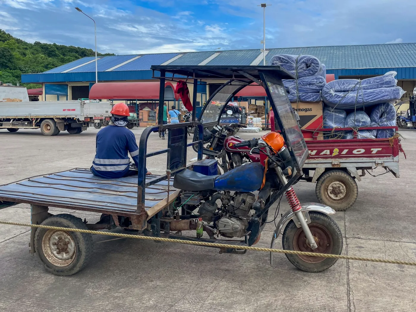 A man on a three-wheeled cargo vehicle