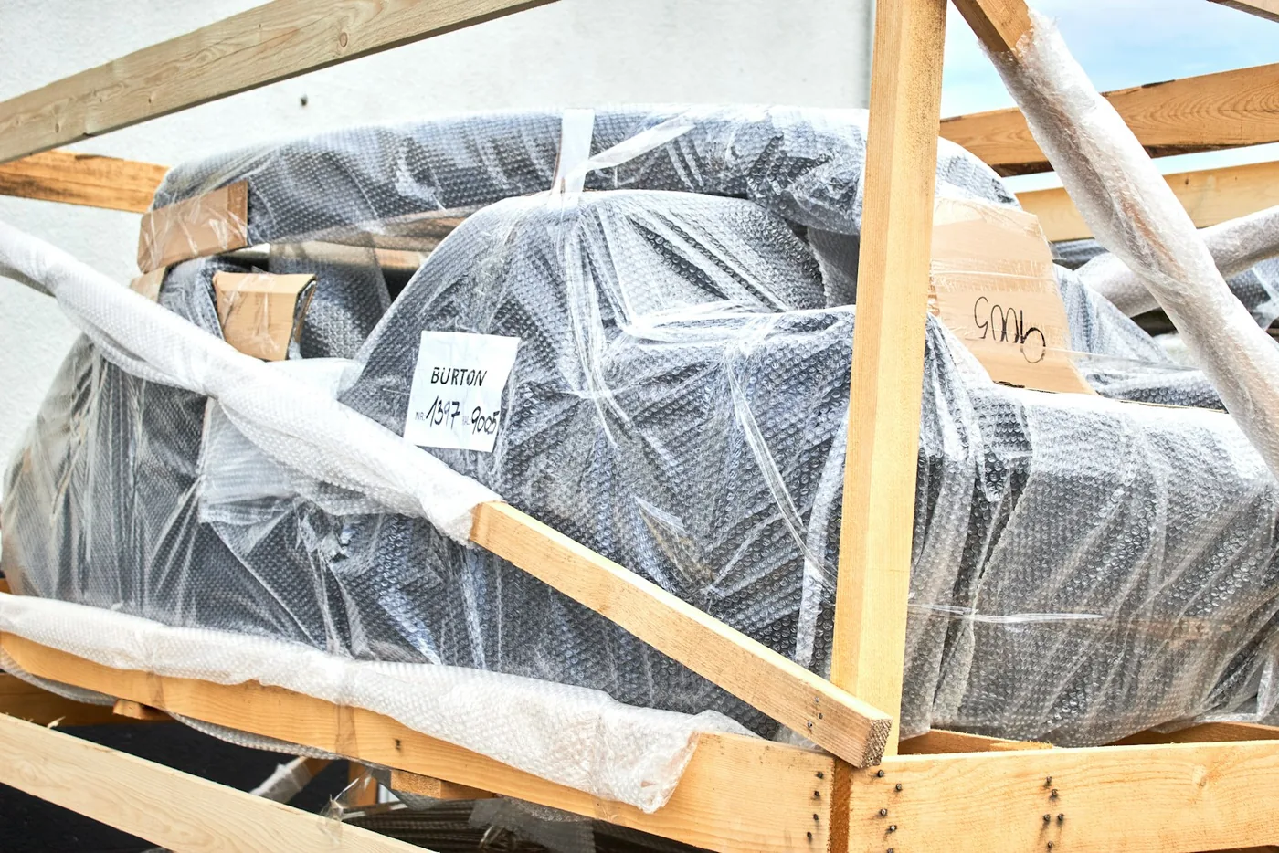A motorcycle wrapped and braced inside a wooden crate