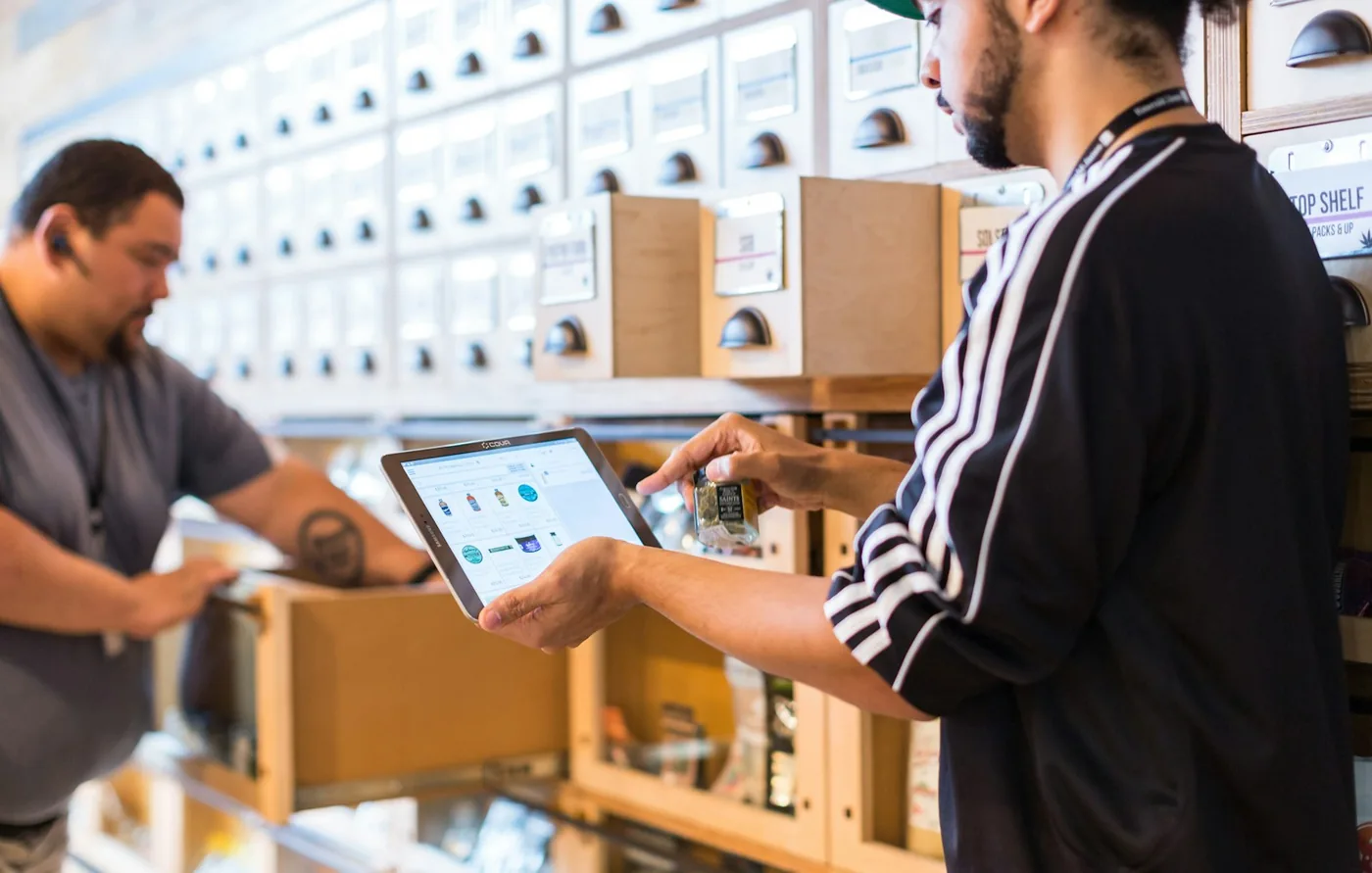 A parcel changing hands across a shop counter