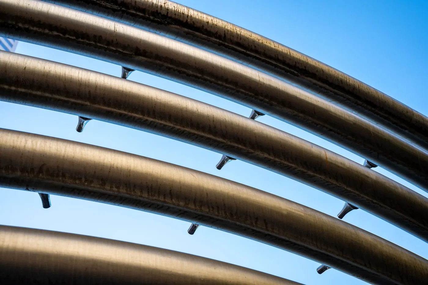 Curved metal tubes against the sky