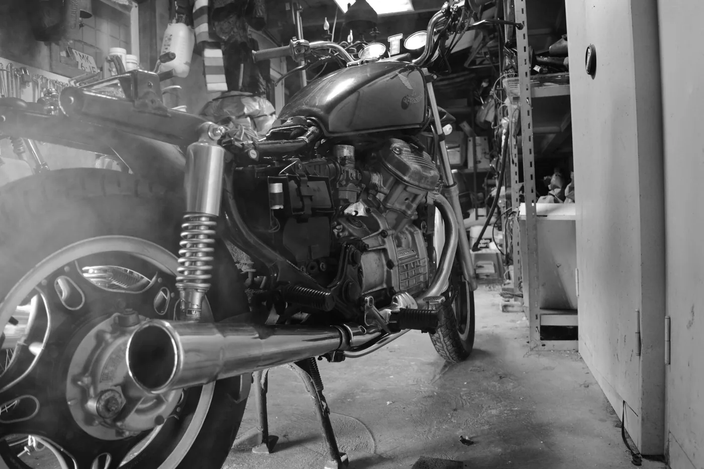 A motorcycle in a workshop, in black and white