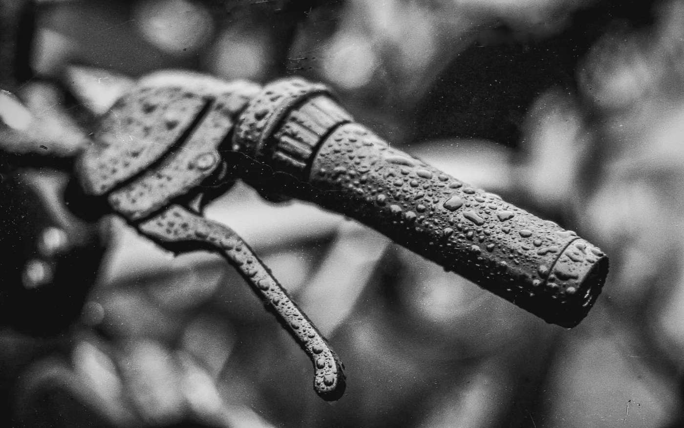 A lever and grip beaded with water