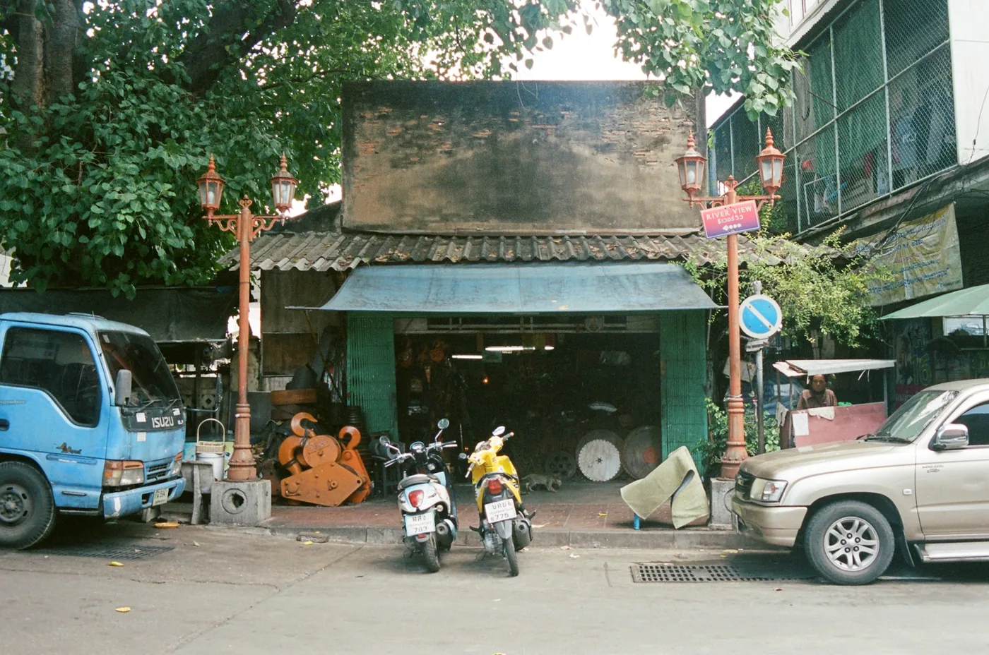 A scooter parked beside a shophouse