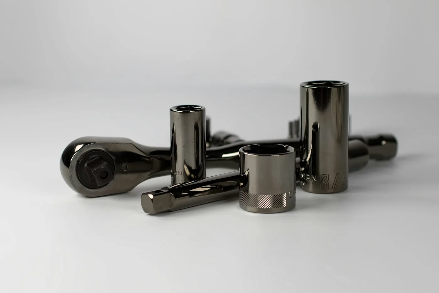 Dark metal cylinders on a white surface